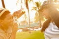 Man Taking Photograph Of Woman In Park Royalty Free Stock Photo