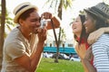 Man Taking Photograph Of Women In Park Royalty Free Stock Photo