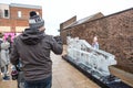 Man taking photography on a mobile phone at ice sculpture festival