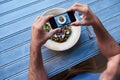 Man taking photos of his salad at a blue table Royalty Free Stock Photo