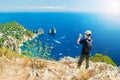 Man taking picture of beautiful landscape on mountain top