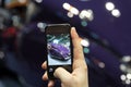 Man taking a picture a moder car at the auto show