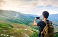 Man taking picture of stunning Asian rice terrace landscape