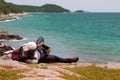 A man is taking pictures of the beautiful sea with his mobile phone in Koh Sichang island in Thailand Royalty Free Stock Photo