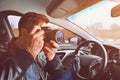 A man is taking pictures from a car window. Photographer traveler. The work of a private detective Royalty Free Stock Photo
