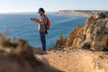 Man taking pictures of ocean landscapes, Ponta da Piedade near Lagos, Portugal