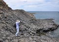A man taking pictures on the rocks in Vung Tau, Vietnam