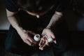 Man taking pills from the container Royalty Free Stock Photo