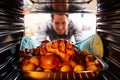 Man Taking Roast Turkey Out Of The Oven Royalty Free Stock Photo