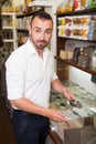 Man taking with scoop cereals sold Royalty Free Stock Photo