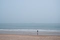 Man taking sea photos far away on beach Royalty Free Stock Photo