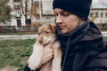 man taking selfie with adorable brown puppy with amazing blue eyes on background of autumn park. space for text. faithful friend Royalty Free Stock Photo