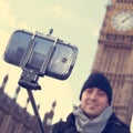 man taking a selfie in front of the Big Ben in London, United Kingdom, with a filter effect Royalty Free Stock Photo