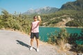 Man taking selfie on mobile phone of mountains lake background. Traveler male having video chat on cellphone on the blue Royalty Free Stock Photo