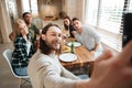 Man taking a selfie photo with friends in the kitchen Royalty Free Stock Photo