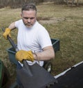 Man taking shingles off a shed roof Royalty Free Stock Photo