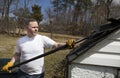 Man taking shingles off a shed roof Royalty Free Stock Photo