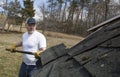 Man taking shingles off a shed roof Royalty Free Stock Photo