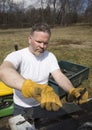 Man taking shingles off a shed roof Royalty Free Stock Photo