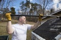 Man taking shingles off a shed roof Royalty Free Stock Photo