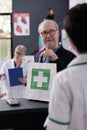 Man taking shopping bag from pharmacy cashier at checkout Royalty Free Stock Photo