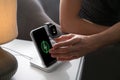 Man taking smartphone from wireless charger in room Royalty Free Stock Photo