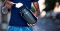 Man taking supplement against blurry street scene