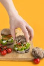 Man taking vegan homemade burger with chickpeas cutlet. Healthy food and green lifestyle. Royalty Free Stock Photo