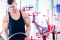 Man taking weights from stand in fitness gym Royalty Free Stock Photo