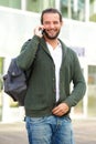 Man talking on cell phone with backpack outside Royalty Free Stock Photo