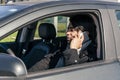 Man talking on cell phone while driving a car. Concept road safety Royalty Free Stock Photo