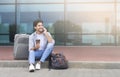 Man Talking On Cellphone And Drinking Takeout Coffee Outside Of Airport Royalty Free Stock Photo