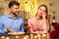 Man talking with hands, uninterested woman at dinner