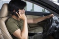 Man talking on mobile phone while driving car. Royalty Free Stock Photo