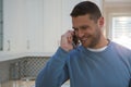 Man talking on mobile phone in kitchen Royalty Free Stock Photo