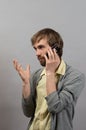 Man talking on the phone. On a gray Royalty Free Stock Photo