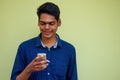 Man talking on the phone india summer holidays.stylish young indian male freelancer working with laptop freelance Royalty Free Stock Photo