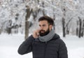 Man talking on phone on snow