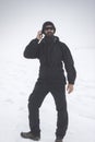 Man talking on phone in the snowy mountain Royalty Free Stock Photo