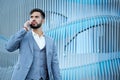 Man talking on smartphone. Businessman urban professional business man using mobile phone. Happy professional wearing suit jacket.