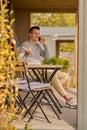 Man talking on smartphone gesturing sitting outdoors Royalty Free Stock Photo