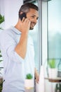 man talking on smartphone stood by window Royalty Free Stock Photo
