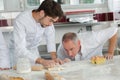 Man talking to chef while preparing dough