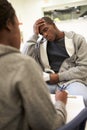 Man Talking To Counsellor Who Takes Notes Royalty Free Stock Photo