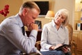 Man Talking To Female Counsellor Using Digital Tab