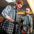 Man talk to colleague glue patch on bike tube