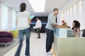 Man Talking To Receptionist At Office