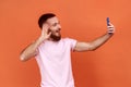 Man talking on video call and waving hello gesture, having online conversation on mobile phone. Royalty Free Stock Photo