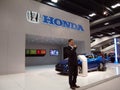 Man talks about Honda cars at booth