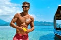 Man Tanning Using Sun Block Body Cream On Summer Beach Royalty Free Stock Photo